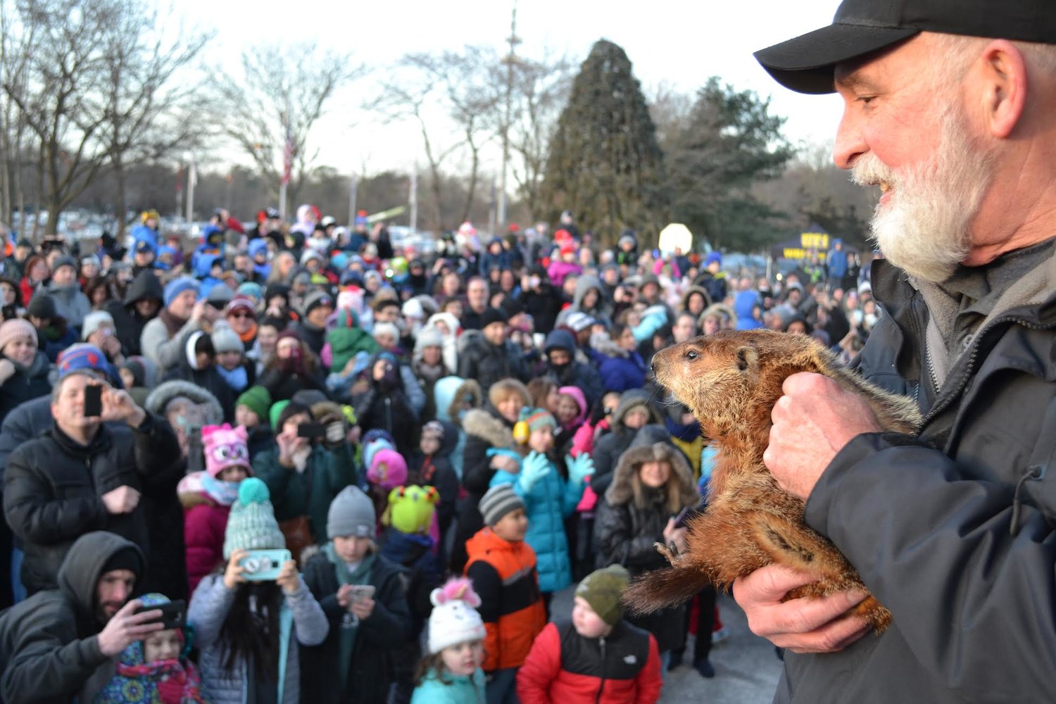 Holtsville Hal’s handler, Gregg Drossel, shows him to the crowd during a previous Groundhog Day celebration.